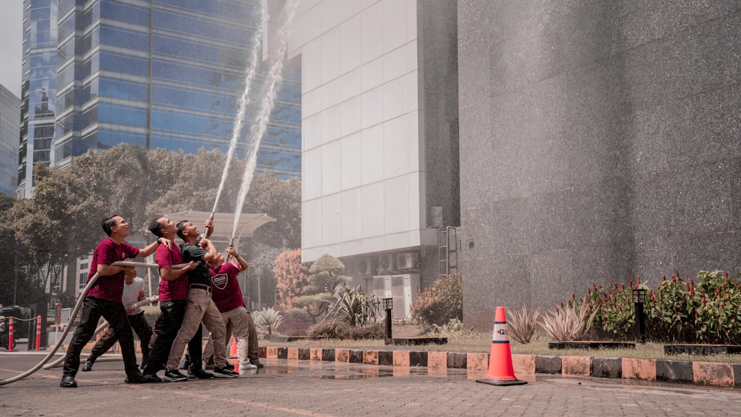 firefighters-spray-water-on-a-building-vxckv6971ly